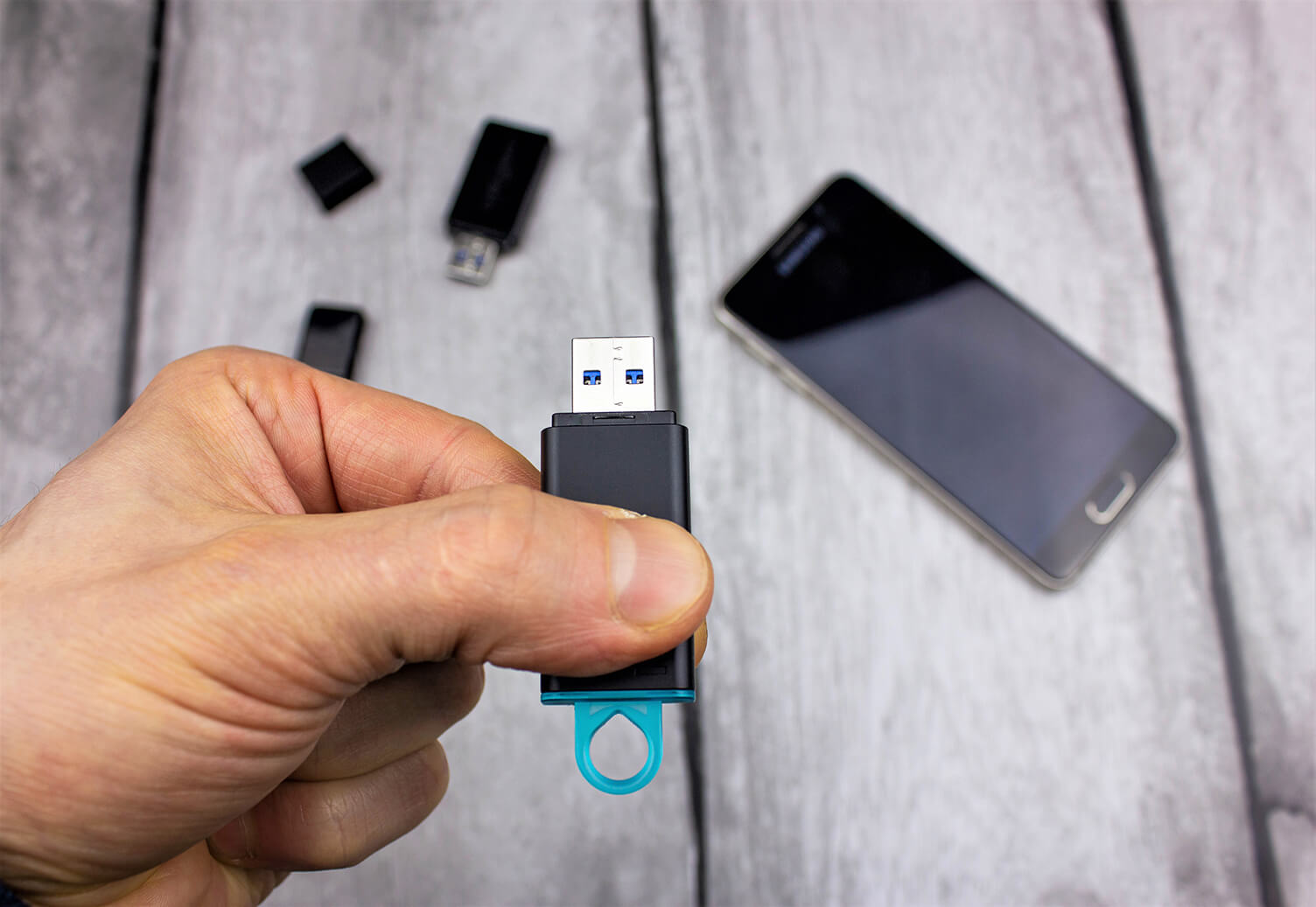 Closeup of a person holding a USB stick that could contain ransomware.